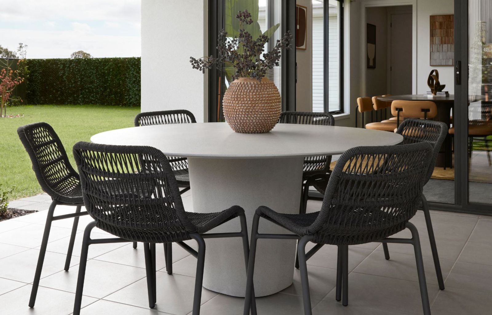 Satara Tiah Armchair and Curve Dining Table - Hickinbotham Display Home